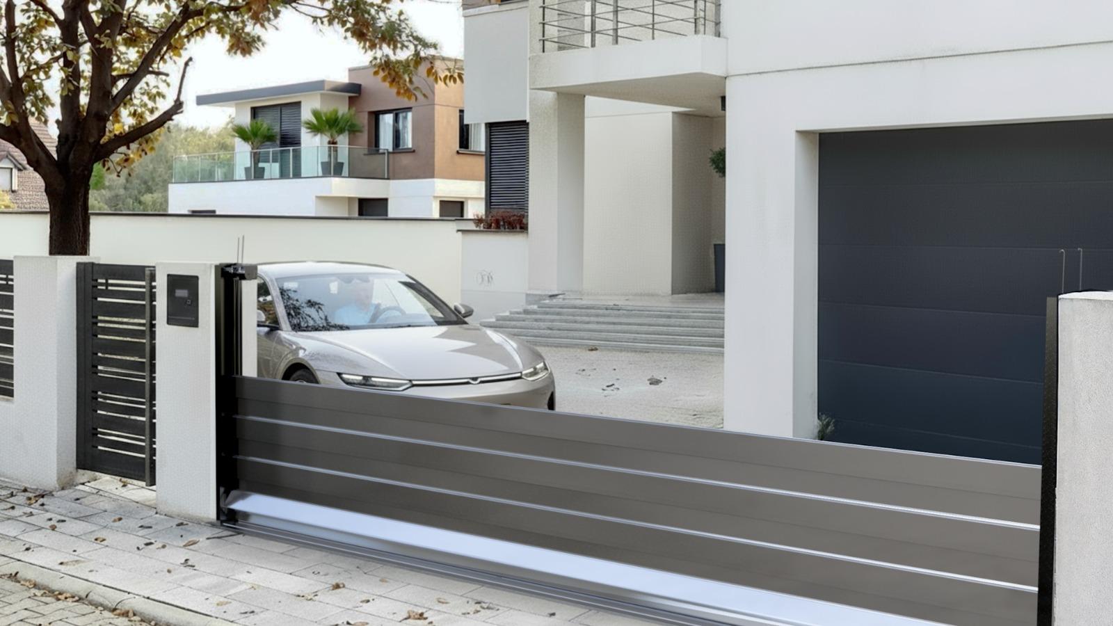Silver car behind a HiddenGate sliding driveway gate